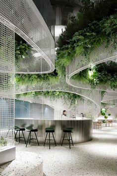 the interior of an office with plants growing on the walls