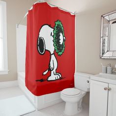 a red shower curtain with a cartoon snoopy christmas wreath on it's head