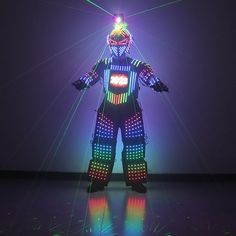 an image of a man that is standing in the dark with lights on his body