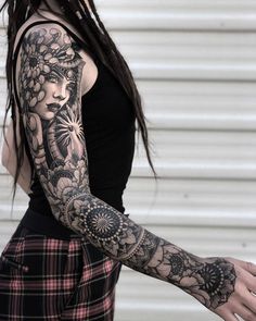 a woman with tattoos on her arm and arms