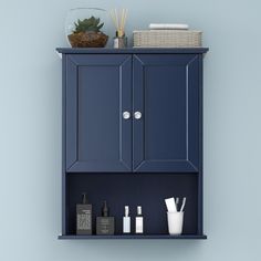 a blue cabinet with two doors and some items on it's shelf next to a basket