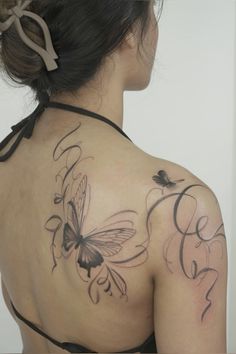 a woman with a butterfly tattoo on her back