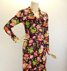 "Vintage 70s long sleeve floral maxi dress, deep wine with pink and orange floral. Sweet 70s maxi dress with long sleeves with ruffled V neck and hem. Full metal zipper in the back. It has a fitted bodice and drapes beautifully. I believe it's a polyester blend and does have some stretch to it. Measured flat  Shoulders 15\" Sleeve 22\" Underarms 16\" 32\" bust waist 14\" 28\" waist Hips 18\" 36\" hip Length 54\"" Stretch Maxi Dress For Garden Party, Stretch Floral Print Midi Maxi Dress, Fitted V-neck Maxi Dress For Fall, Chic Fitted Floral Print Maxi Dress, Long Sleeve Printed Dress For Garden Party, Vintage V-neck Floral Dress For Spring, Chic Fitted Long Floral Dress, Fitted V-neck Printed Dresses, Fitted Long Floral Dress For Party