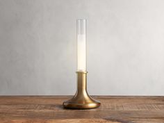 a gold colored candle holder on a wooden table