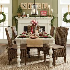 an image of a dining room set with christmas decorations on the fireplace mantels