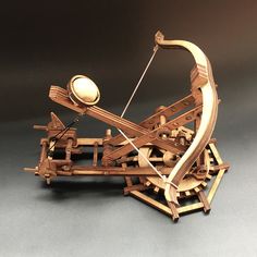 a wooden model of an old spinning wheel