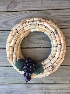 a wreath made out of wine corks and grapes