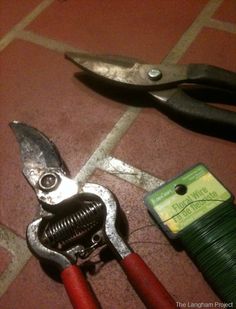 some tools are laying on the floor next to each other, including wire cutters and pliers