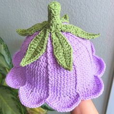 a crocheted hat with leaves attached to it