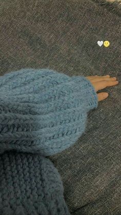 a person's feet in blue knitted slippers