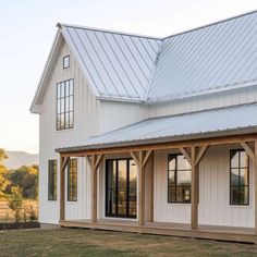 a large white house with wooden beams and windows