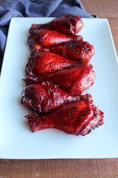 several pieces of meat on a white plate