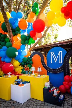 colorful balloons and streamers decorate the entrance to a birthday party at mj's