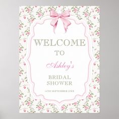 a welcome sign with a pink bow on it's head and flowers around the edges