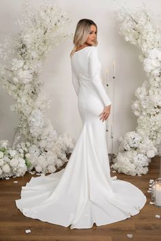 This modest yet chic wedding gown features sophisticated boat neckline and double-layer stretch crepe for optimum figure flattery. Elegantly complementing it is a fitted long-sleeve bodice flowing into a mermaid sweep train that forms a striking silhouette. Noodz Boutique, Wedding Dresses Under 500, Chic Wedding Gown, Crepe Gown, Affordable Wedding Dresses, Sleeve Wedding Dress, Modest Wedding Dresses, Stretch Crepe, Boat Neckline