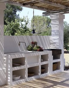 an outdoor kitchen is built into the side of a house