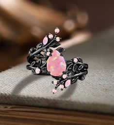 Unique Pear Pink Fire Opal Engagement ring Set Gothic Art deco Black Gold Cluster Vine Leaf Wedding Band Vintage Stacking Bridal Promise Set Applicable scene: anniversary, birthday party, wedding, engagement, gift ■ Handmade, high-quality item! ■ Material: S925 Sliver SOLID 14K/18K BLACK GOLD (can be made in white/rose/yellow gold) Engagement ring ■ Center stone: Pink Opal ■ Size/Weight: 6*8mm pear ■ Side stones: Pink Opal ■ Total weight: 0.042 ct (High Quality) ■ Cut - VG ■ Color: G-H ■ Clarity Unique Purple Engagement Rings, Black And Pink Wedding Rings, Ethereal Wedding Rings, Unique Opal Engagement Rings, Black Band Engagement Ring, Engagement Rings Fairy, Goth Wedding Rings, Unique Engagement Rings Vintage Antiques, Flashy Engagement Rings