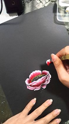 a woman is drawing on a piece of paper