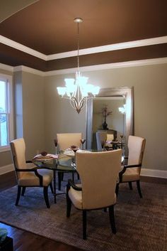 a dinning room table with chairs and a chandelier