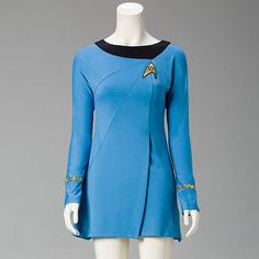 a blue dress with black trims and a star trek insignia on it