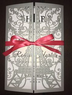 the inside of a wedding card with a red ribbon on it and an intricate design