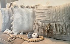 pillows and beads on a couch in a living room