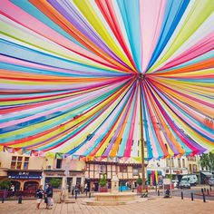 a large multicolored canopy in the middle of a square