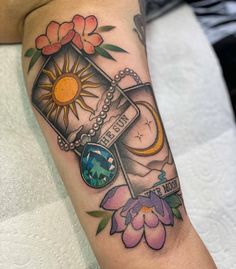 a woman's arm with a clock and flowers on it