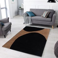 a living room with two chairs and a rug on the floor