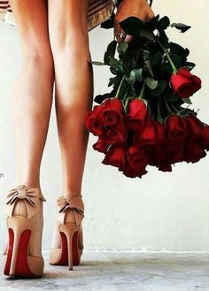 there is a woman with high heels holding roses