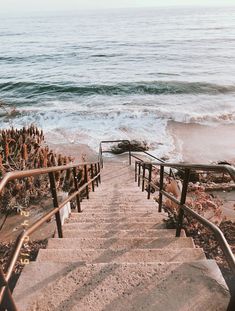 the stairs lead down to the beach where there is no one in sight or anything else