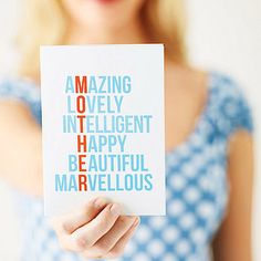 a woman holding up a card with words in different languages