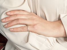 a close up of a person's hand wearing a ring