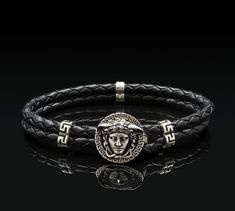 Sterling silver bracelet with Medusa motif and meanders. Genuine braided leather. 𝐏𝐑𝐎𝐃𝐔𝐂𝐓 𝐃𝐄𝐓𝐀𝐈𝐋𝐒 Genuine braided leather. length: 21 cm / 8.26" width: 0.7cm / 0.27" diameter coin: 1.8 cm / 0.70" Made of 925⁰ sterling silver. ★ Handmade in Greece The bracelet can be made in any desired length (shorter or longer). Please enter the length you want in the buyer's note. Medusa, in Greek mythology, the most famous of the monster figures known as Gorgons, is generally described as a wing Luxury Adjustable Engraved Leather Bracelet, Genuine Leather Bracelet, Leather Product, Bracelet Mens, Greek Goddess, Braided Bracelets, Braided Leather, Greek Mythology, Sterling Silver Bracelets