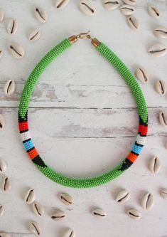 Classic Maasai beaded necklace. Beautifully handmade my Kenyan artisans. Handmade Festival Necklaces With Round Beads, Traditional Handmade Long Beaded Necklace, Traditional Green Hand-strung Beaded Necklaces, Traditional Green Hand-strung Necklaces, Traditional Green Hand-strung Necklace, Traditional Green Long Necklace Beads, Handmade Multicolor Long Bead Necklace, Unique Small Beads As Gift, Long Traditional Green Necklace