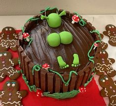 there is a chocolate cake decorated with green decorations