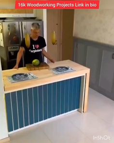 a man standing in front of a kitchen counter with an apple on top of it