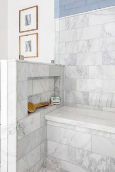 a bathroom with white marble walls and floor