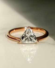 a close up of a diamond ring on a table