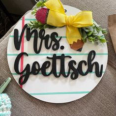 a sign that says mrs geetsch with a yellow bow on the front and bottom