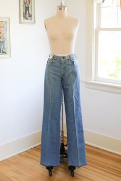 Rare 1970s old-store stock 100% cotton denim flares in a range of killer medium wash blues.  Belt loops, marigold top stitching, copper rivets and lightning bolt branded button. Leather branded rear patch. Front metal Scovill zipper. Lower rise. These flared legs make your legs look longlonglong. Hems are serged and were intended to be cuffed as shown on model or hemmed to suit the new owner perfectly. Model shown is a size 2 and is about 5'7" in flat shoes. The extra long inseams are also great Retro Wide Leg Light Wash Flare Jeans, Vintage Fitted Denim Blue Flare Jeans, Fitted Vintage Denim Blue Flare Jeans, Retro Flare Jeans With Light Wash, Vintage Fitted Flare Jeans In Denim Blue, Vintage Faded Pants, Retro Full-length Light Wash Flare Jeans, Vintage High Rise Flare Jeans For Spring, Fitted Vintage Flare Jeans With Five Pockets