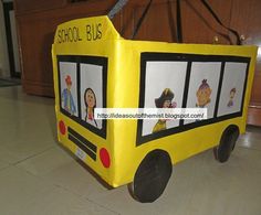 a school bus made out of cardboard sitting on the floor