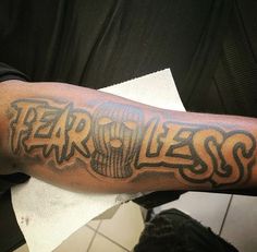 a man with a tattoo on his arm that says fearless