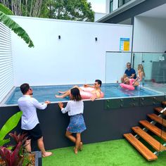 two people are playing with an inflatable pool