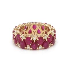 a yellow gold ring with red stones and diamonds