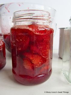 a jar filled with liquid sitting on top of a table next to a blender