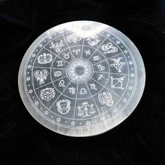 the zodiac sign is etched into an acrylic glass plate on top of black fur