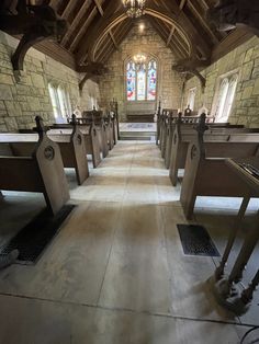 an empty church with pews and stained glass windows