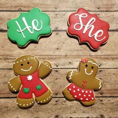 three decorated cookies sitting on top of a wooden table