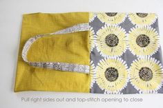 a yellow and gray flowered cloth with measuring tape on the side, next to it